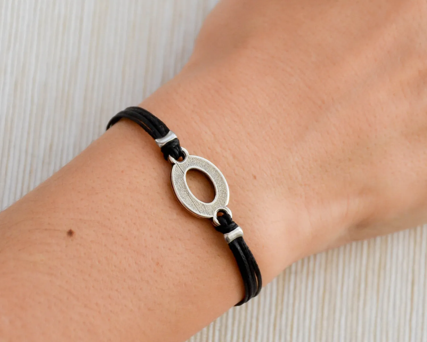 Black cord bracelet with a silver oval circle charm, Mothers day gift