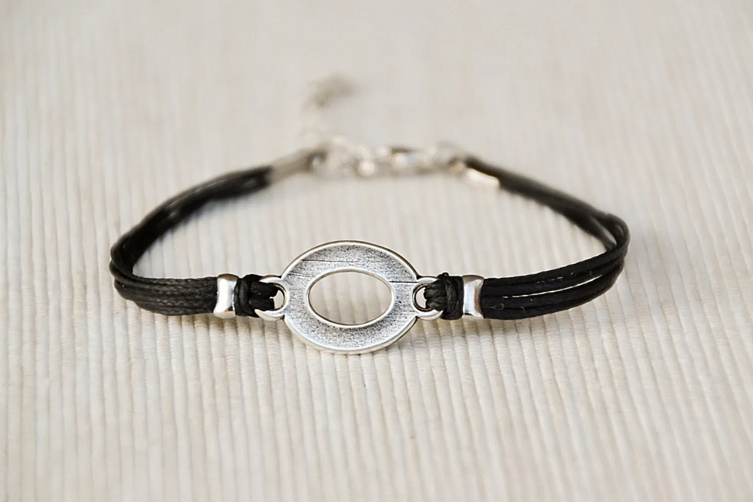 Black cord bracelet with a silver oval circle charm, Mothers day gift